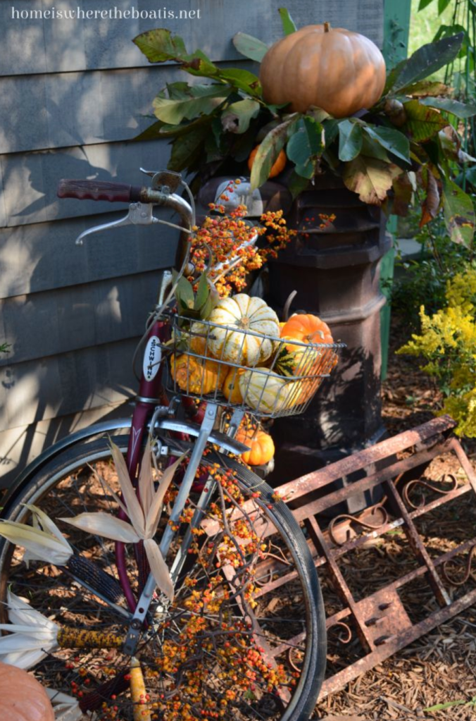 bicycle with fall decorations, including pumpkins in a basket